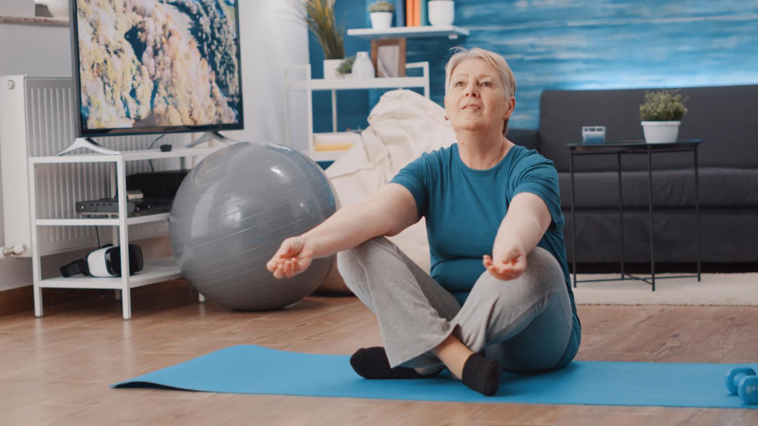 Yoga instructor leading an office yoga session with participants in a bright workspace